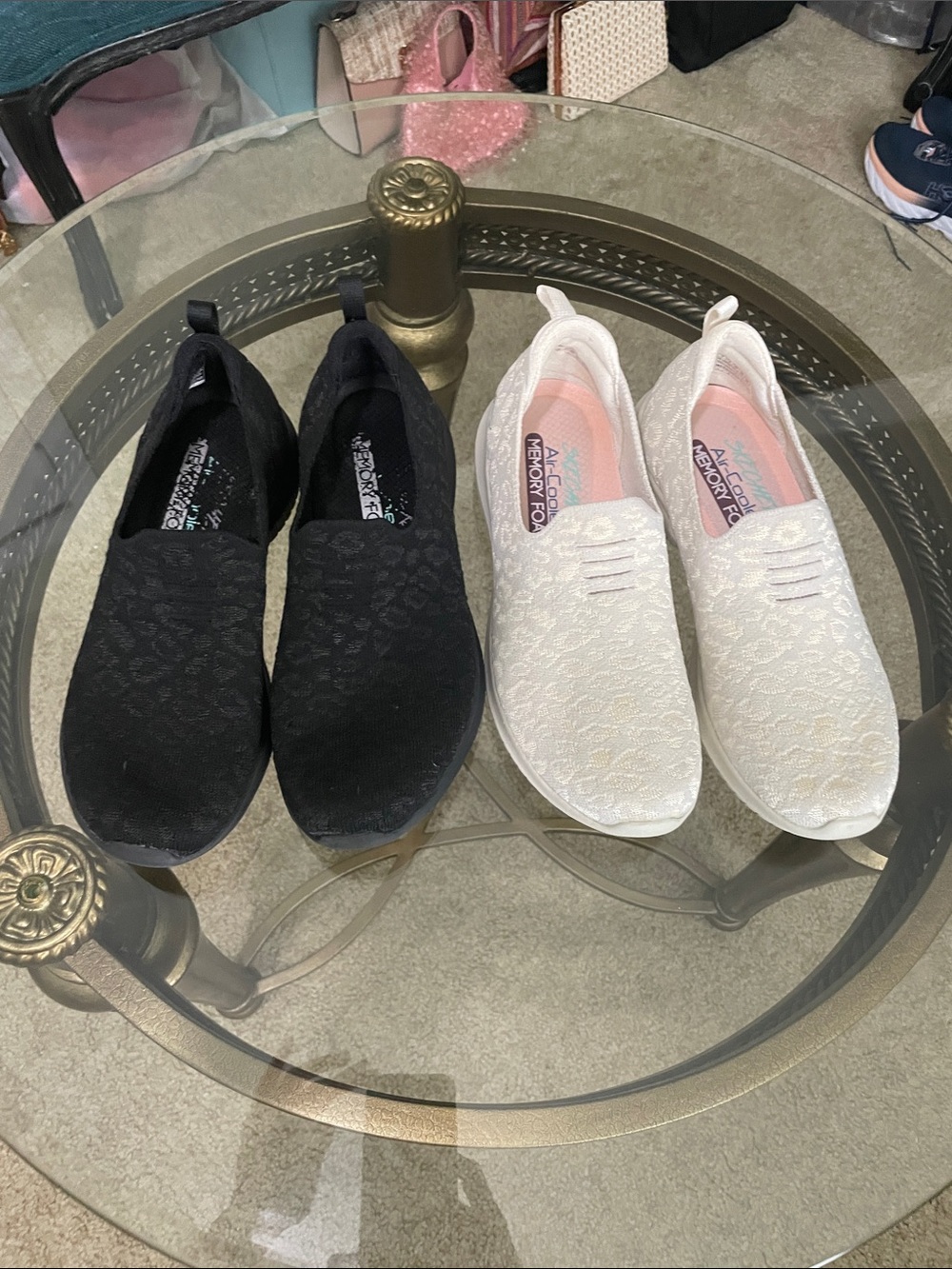 Two pair of Skechers Lightweight Slip-On Sneakers in Black and cream